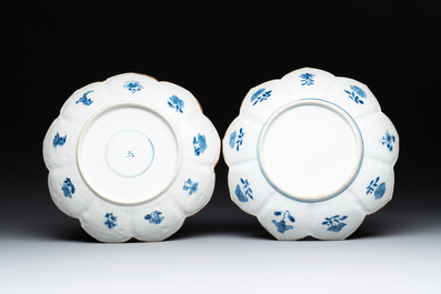 A pair of Chinese lotus-shaped blue and white plates with floral design, yu mark, Kangxi