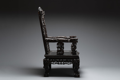 A Chinese richly carved and lacquered hongmu armchair, Canton, 19th C.