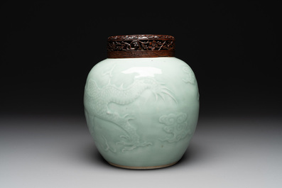 A Chinese celadon-glazed 'dragon' jar with reticulated wooden cover and stand, Qianlong