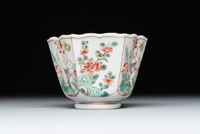 A fine Chinese famille verte 'boy and lotus' flower-shaped cup and a wooden stand, Kangxi