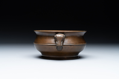 A Chinese bronze elephant-head-handled censer, Wan Shou Wu Jiang 萬壽無疆 mark, 19th C.