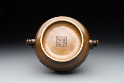 A Chinese bronze elephant-head-handled censer, Wan Shou Wu Jiang 萬壽無疆 mark, 19th C.