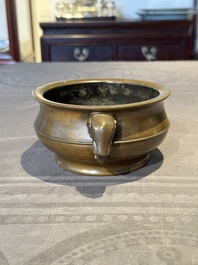 A Chinese bronze elephant-head-handled censer, Wan Shou Wu Jiang 萬壽無疆 mark, 19th C.