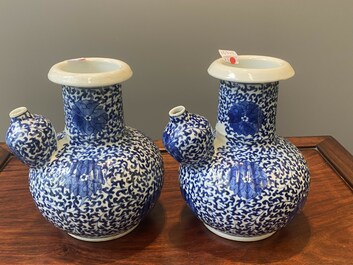 A pair of Chinese blue and white 'lotus scroll' kendis, 19th C.