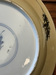 A Chinese famille verte caf&eacute;-au-lait ground plate and a white-glazed plate, Kangxi