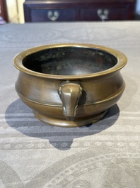 A Chinese bronze elephant-head-handled censer, Wan Shou Wu Jiang 萬壽無疆 mark, 19th C.