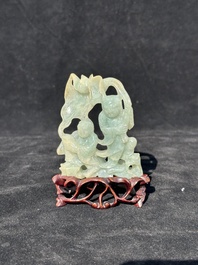 A Chinese jade 'He He Er Xian' group on wooden stand, 19th C.
