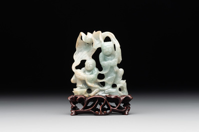 A Chinese jade 'He He Er Xian' group on wooden stand, 19th C.