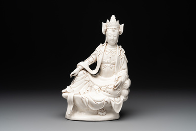 A Chinese Dehua blanc de Chine seated Guanyin holding a sutra, 20th C.