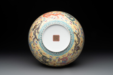 Two Chinese eggshell famille rose 'dragon' bowls on wooden stands, Qianlong mark, 20th C.