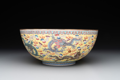 Two Chinese eggshell famille rose 'dragon' bowls on wooden stands, Qianlong mark, 20th C.
