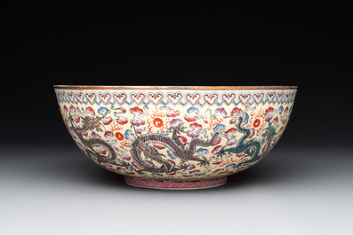 Two Chinese eggshell famille rose 'dragon' bowls on wooden stands, Qianlong mark, 20th C.