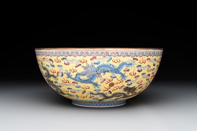 Two Chinese eggshell famille rose 'dragon' bowls on wooden stands, Qianlong mark, 20th C.