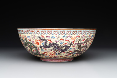 Two Chinese eggshell famille rose 'dragon' bowls on wooden stands, Qianlong mark, 20th C.