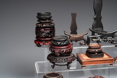 A collection of 55 Chinese wooden stands, 19/20th C.
