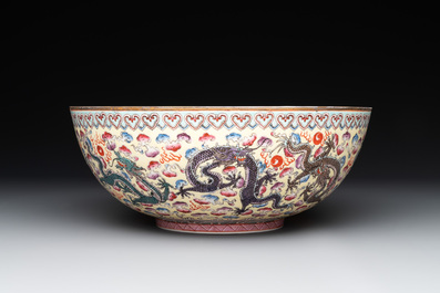 Two Chinese eggshell famille rose 'dragon' bowls on wooden stands, Qianlong mark, 20th C.