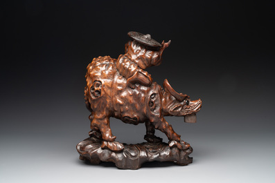 A Chinese carved wooden group of a boy riding a water buffalo, 20th C.