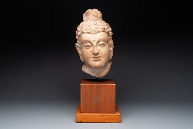 A large terracotta head of Buddha Shayamuni, Gandhara region, Kushan period, 4/5th C.