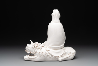 A Chinese Dehua blanc de Chine Guanyin seated on a Buddhist lion, 20th C.
