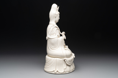 A Chinese Dehua blanc de Chine Guanyin seated on a lotus throne, 20th C.