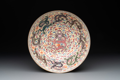 Two Chinese eggshell famille rose 'dragon' bowls on wooden stands, Qianlong mark, 20th C.