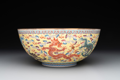 Two Chinese eggshell famille rose 'dragon' bowls on wooden stands, Qianlong mark, 20th C.