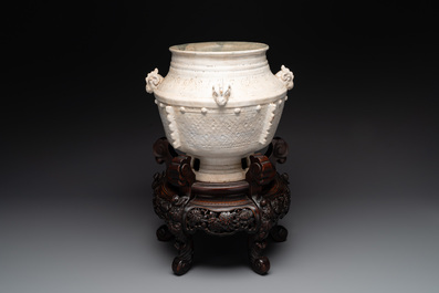 A Chinese archaistic white-glazed vase on wooden stand, Qing