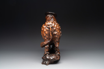 A Chinese carved wooden group of a boy riding a water buffalo, 20th C.