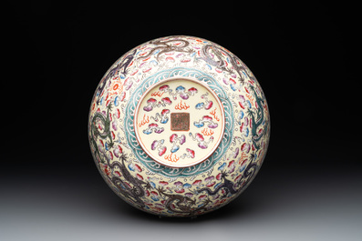 Two Chinese eggshell famille rose 'dragon' bowls on wooden stands, Qianlong mark, 20th C.