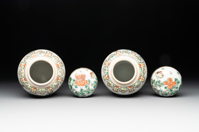 A pair of Chinese famille verte 'pheasant among flowering branches' vases and covers, 19th C.