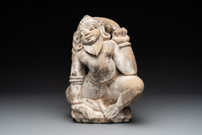 An Indian polychromed stone sculpture of a deity, 18/19th C.