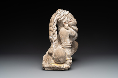An Indian polychromed stone sculpture of a deity, 18/19th C.