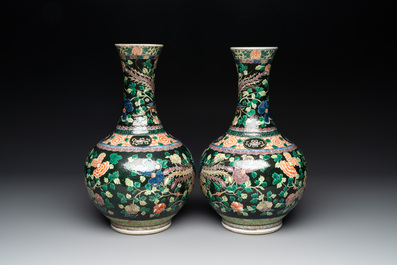 A pair of Chinese famille verte black-ground 'phoenix' bottle vases, Qianlong mark, 19th C.