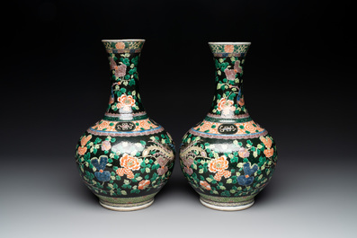 A pair of Chinese famille verte black-ground 'phoenix' bottle vases, Qianlong mark, 19th C.