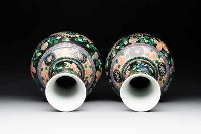 A pair of Chinese famille verte black-ground 'phoenix' bottle vases, Qianlong mark, 19th C.
