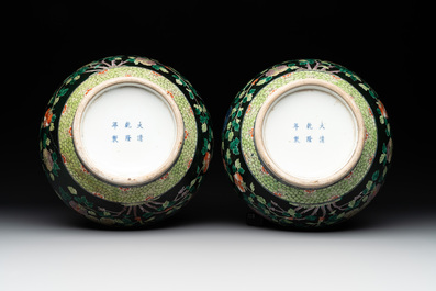 A pair of Chinese famille verte black-ground 'phoenix' bottle vases, Qianlong mark, 19th C.