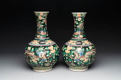 A pair of Chinese famille verte black-ground 'phoenix' bottle vases, Qianlong mark, 19th C.