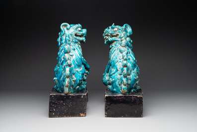 A pair of Chinese turquoise-and-aubergine-glazed Buddhist lions on stands, probably Swatow kilns, 19th C.