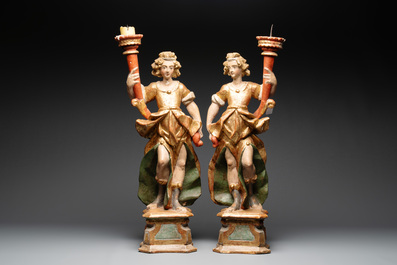 A pair of gilt and polychromed wooden angel-form candlesticks, Germany, 18/19th C.