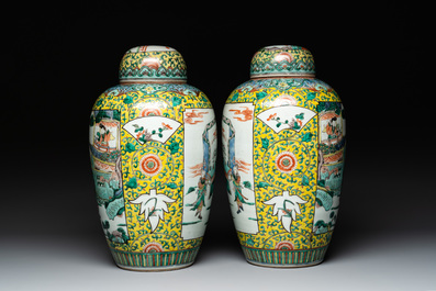 A pair of Chinese famille verte yellow-ground vases and covers with narrative design, 19th C.