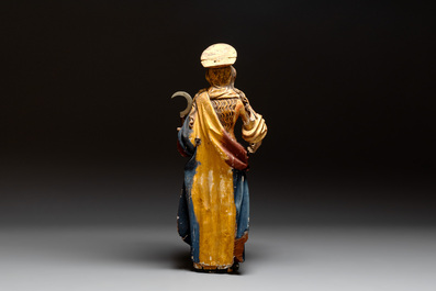 A large gilt and polychromed wooden sculpture of a female saint with a sickle, Germany, 18th C.