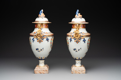 A pair of Chinese export famille rose urns and covers, Qianlong