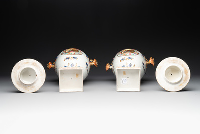 A pair of Chinese export famille rose urns and covers, Qianlong