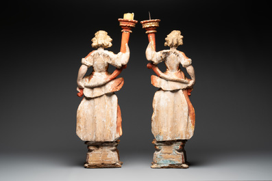 A pair of gilt and polychromed wooden angel-form candlesticks, Germany, 18/19th C.