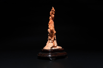 A Chinese red coral group of boys and bitter gourds on wooden stand, 19/20th C.