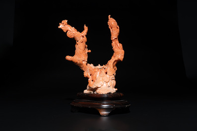 A Chinese red coral group of boys and bitter gourds on wooden stand, 19/20th C.