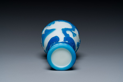 A Chinese blue-overlay white Beijing glass 'meiping' vase, a bowl and a bottle, 19/20th C.