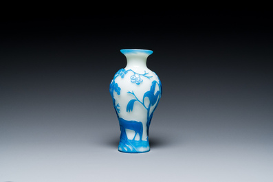 A Chinese blue-overlay white Beijing glass 'meiping' vase, a bowl and a bottle, 19/20th C.
