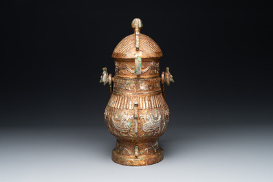 A Chinese archaistic bronze 'you 卣' vessel and cover, an inkstone and two calligraphy brushes, 20th C.