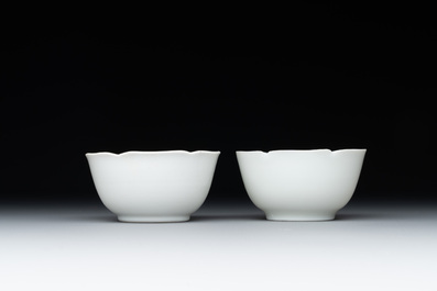 A pair of Chinese eggshell white-glazed cups and saucers, and two famille rose cups, 18th C.